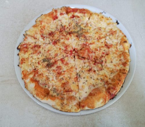 Pizza with various toppings and a generous amount of cheese.