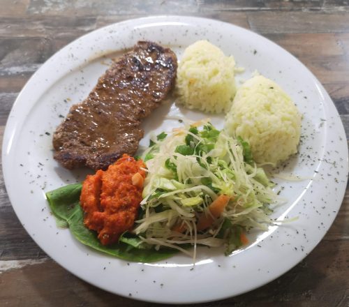 Beefsteak with rice and lettuce.